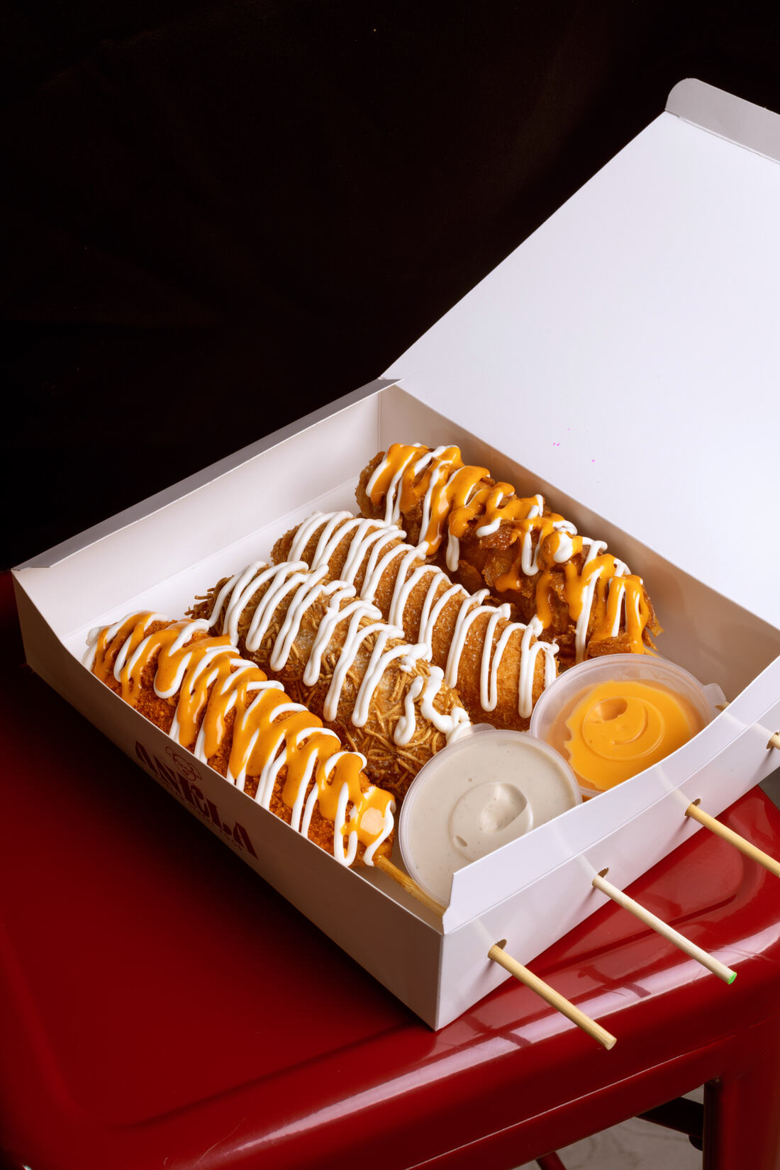 Caja de tres Korndogs con salsas de queso y alioli